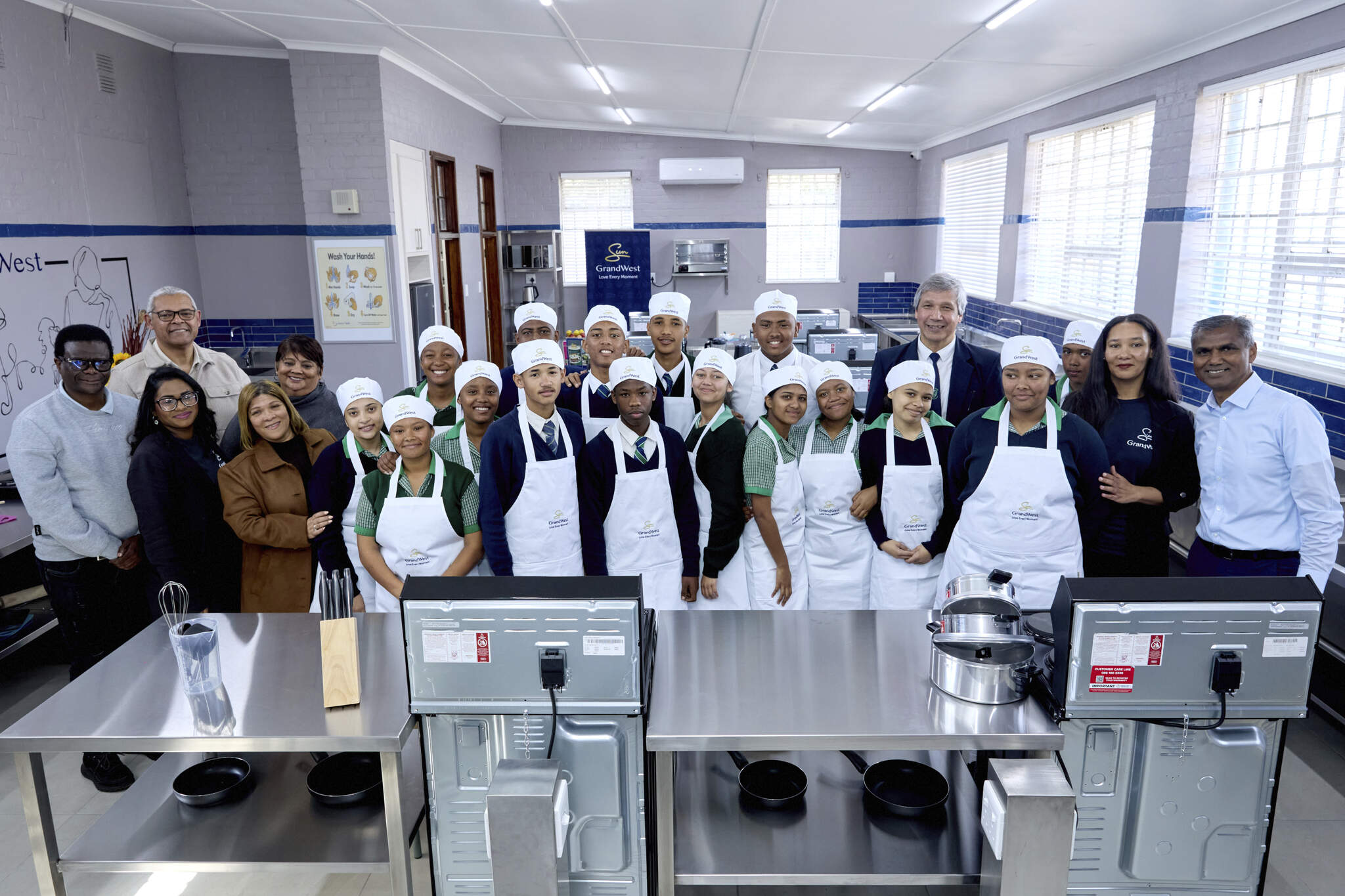 Merwyn Naidoo, General Manager at GrandWest (far right) with learners and staff at Bishop Lavis High School.
