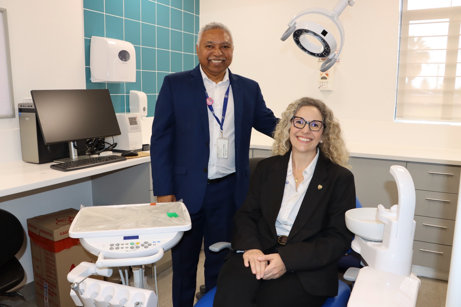 Minister Mireille Wenger (seated) and Alfonso Patientia from the Western Cape Government in the new dental room at Ravensmeand CDC.