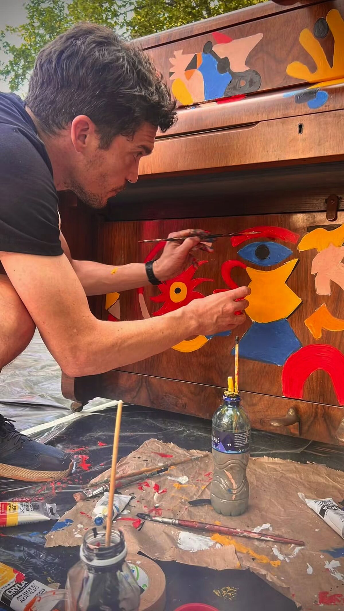 Maximillian Goldin painting one of the pianos.