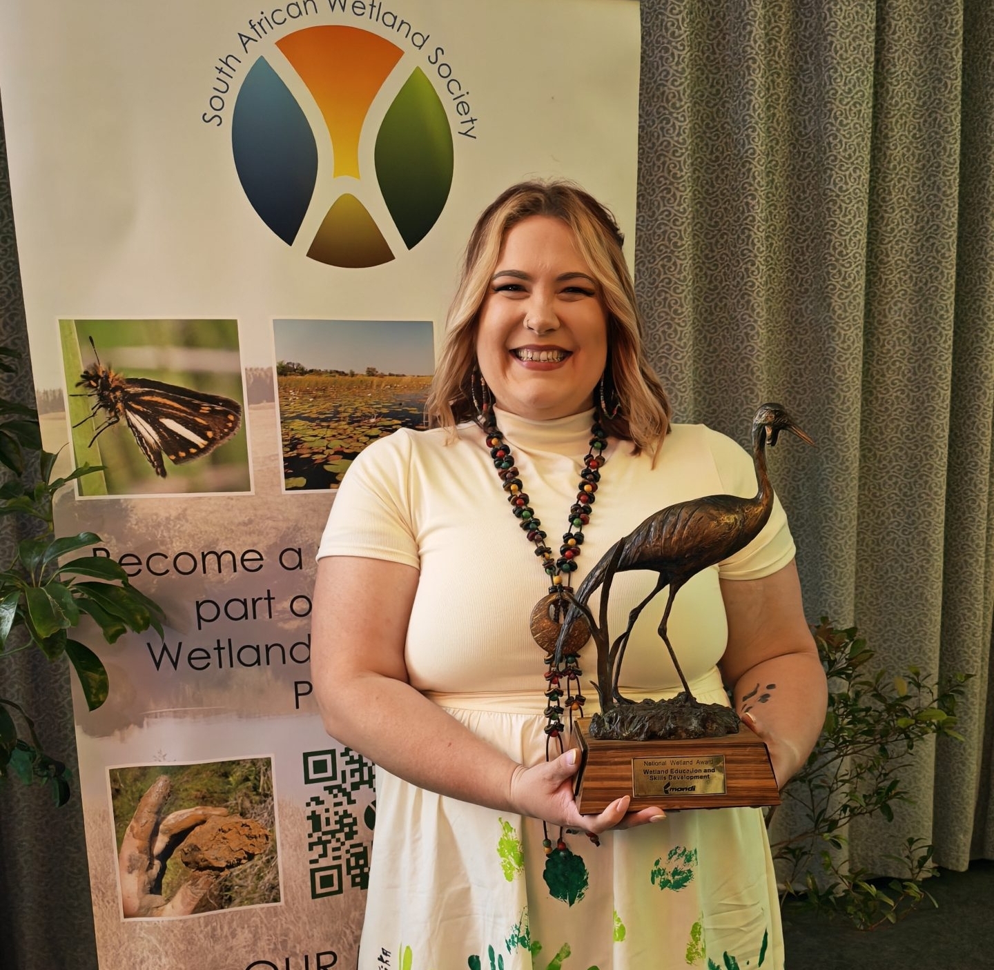 Danielle Cronje, director and co-founder of the MRCT, with the NWI award for Education & Skills Development.