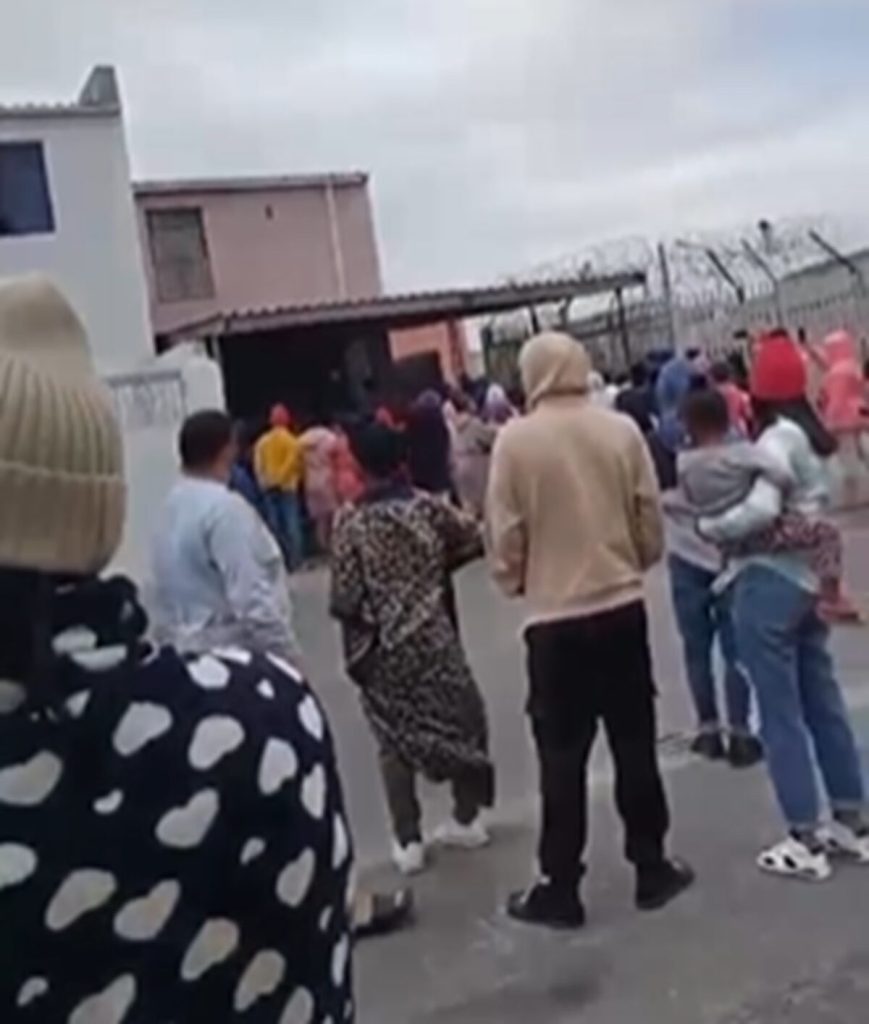 A group of residents watching events unfold in Tafelsig.