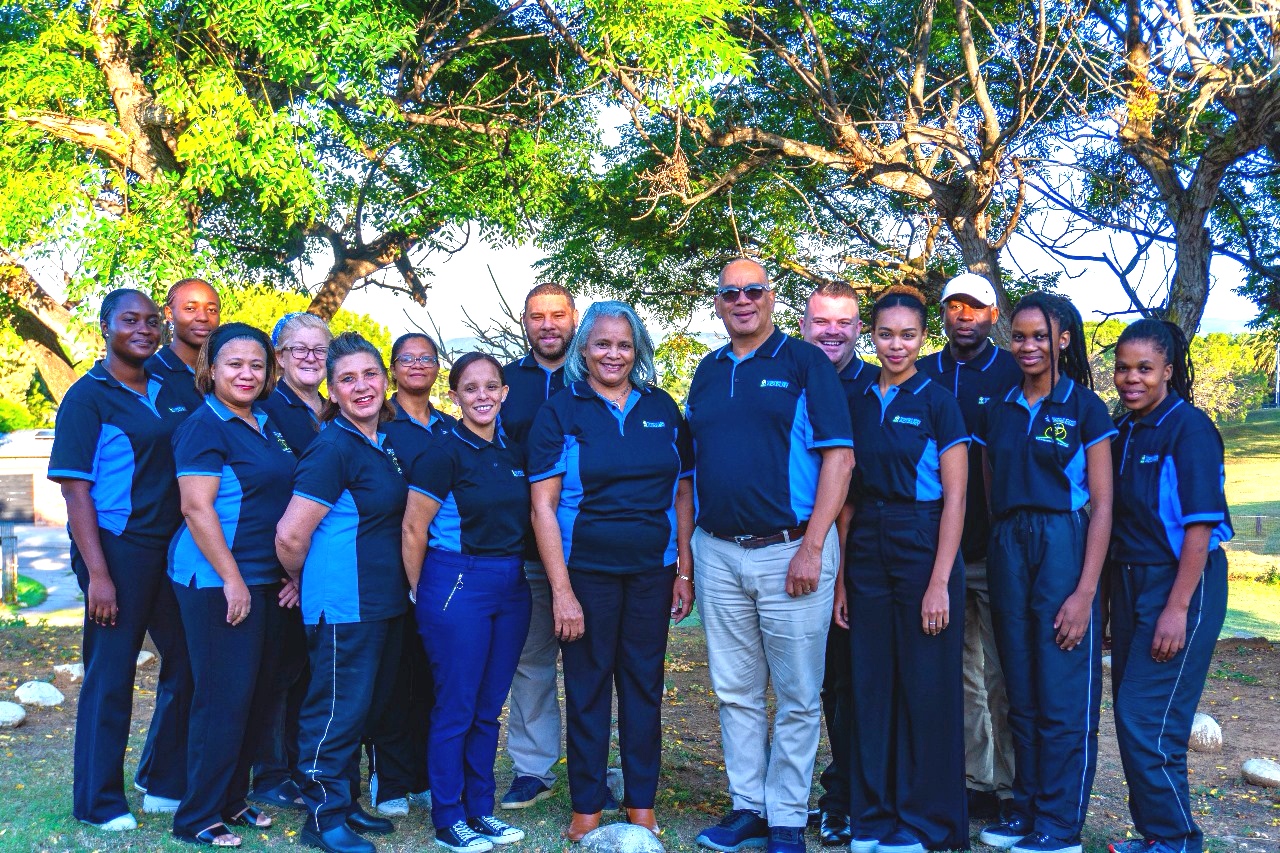 A large group of people standing alongside each other.