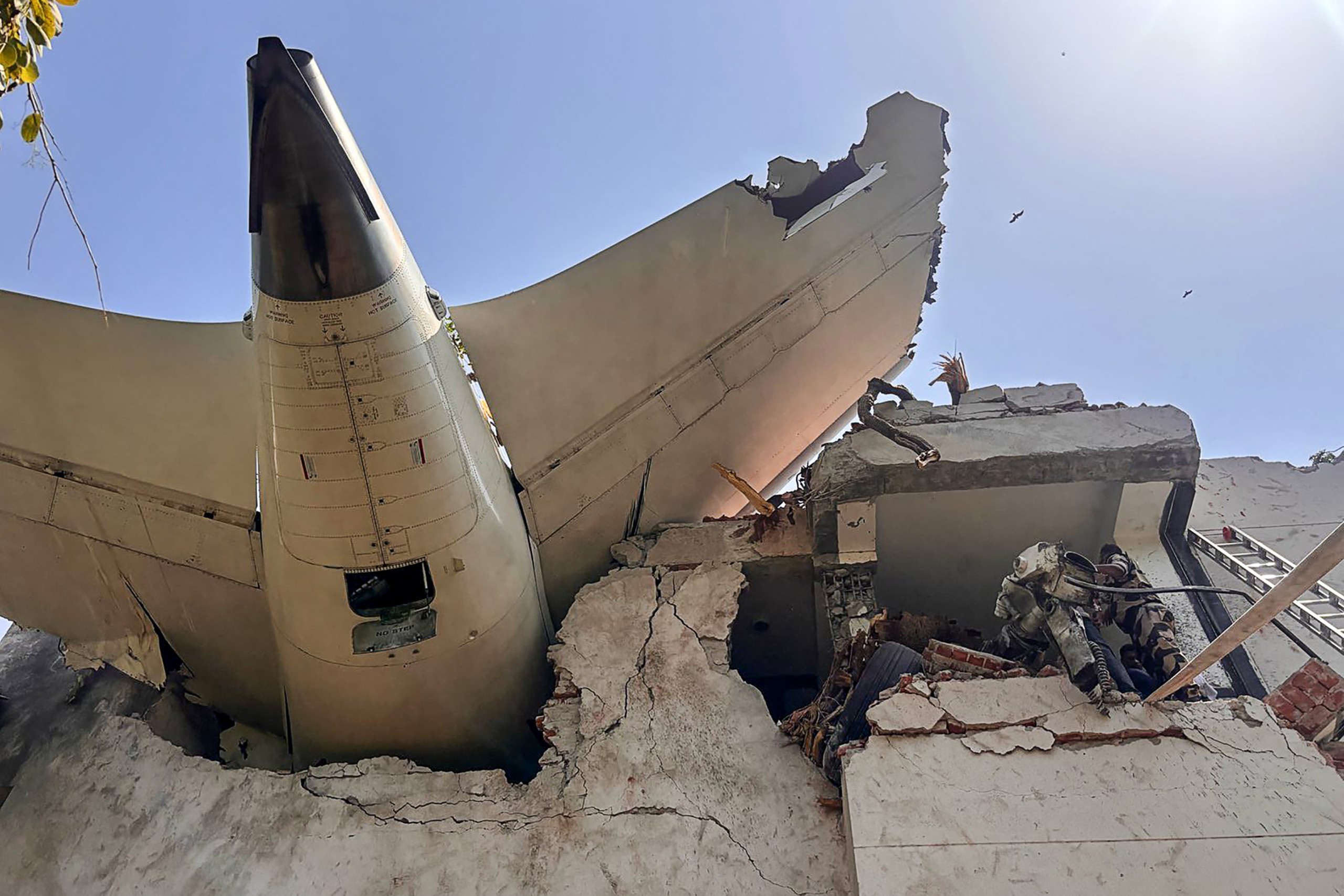 The tailpiece of Air India flight AI171 after it crashed in a residential area near the airport in Ahmedabad