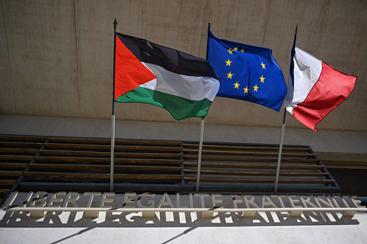 The Palestinian flag is displayed on the Grabels' town hall, near Montpellier, southern France, next to European and French flags on September 22, 2025. Frances interior ministry has ordered prefects to oppose the display of Palestinian flags on town halls and other public buildings. The warning from the interior ministry came after Socialist leader Olivier Faure called for the Palestinian flag to be flown on town halls on September 22, 2025. (Photo by GABRIEL BOUYS / AFP)
