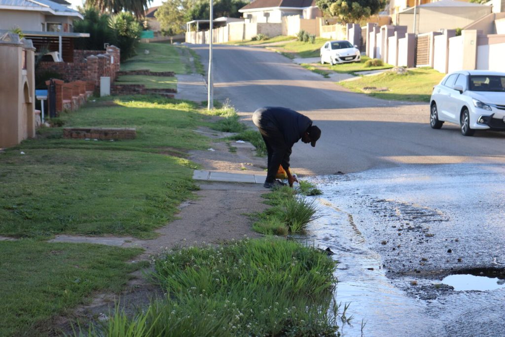 The flow of potable water down the street into the drain for allegedly over a year has become a free water supply for residents.
