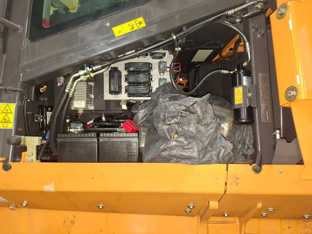 Suspected cocaine blocks hidden within an excavator's engine compartment panel at Durban harbour.