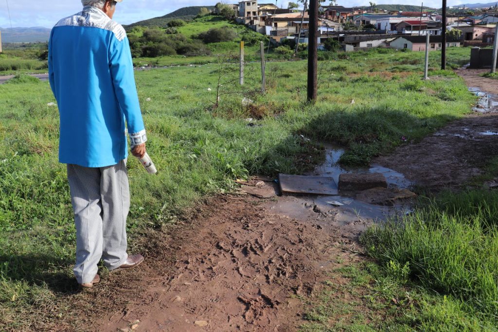 A resident showing the 'Express' the extent of the sewage next to his home.