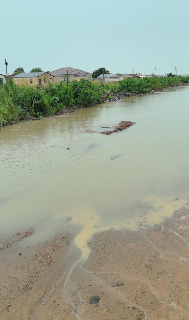 Floodwater entered homes, roads became impassable, and emergency services and water-delivery vehicles were unable to reach residents.