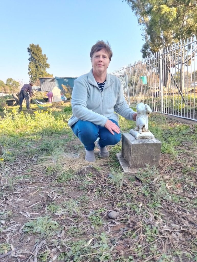 Tharina Coetzee, organiseerder van die opruiming in Ventersburg, by een van die gevandaliseerde kindergrafte in die Voortrekker-begraafplaas.