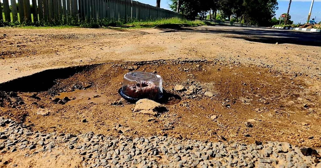 A normal size birthday cake looks very tiny in the