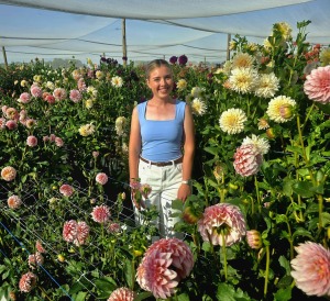 Jong boervrou deel liefde vir blomme wyd en oorvloedig, soos armsvol ruikers