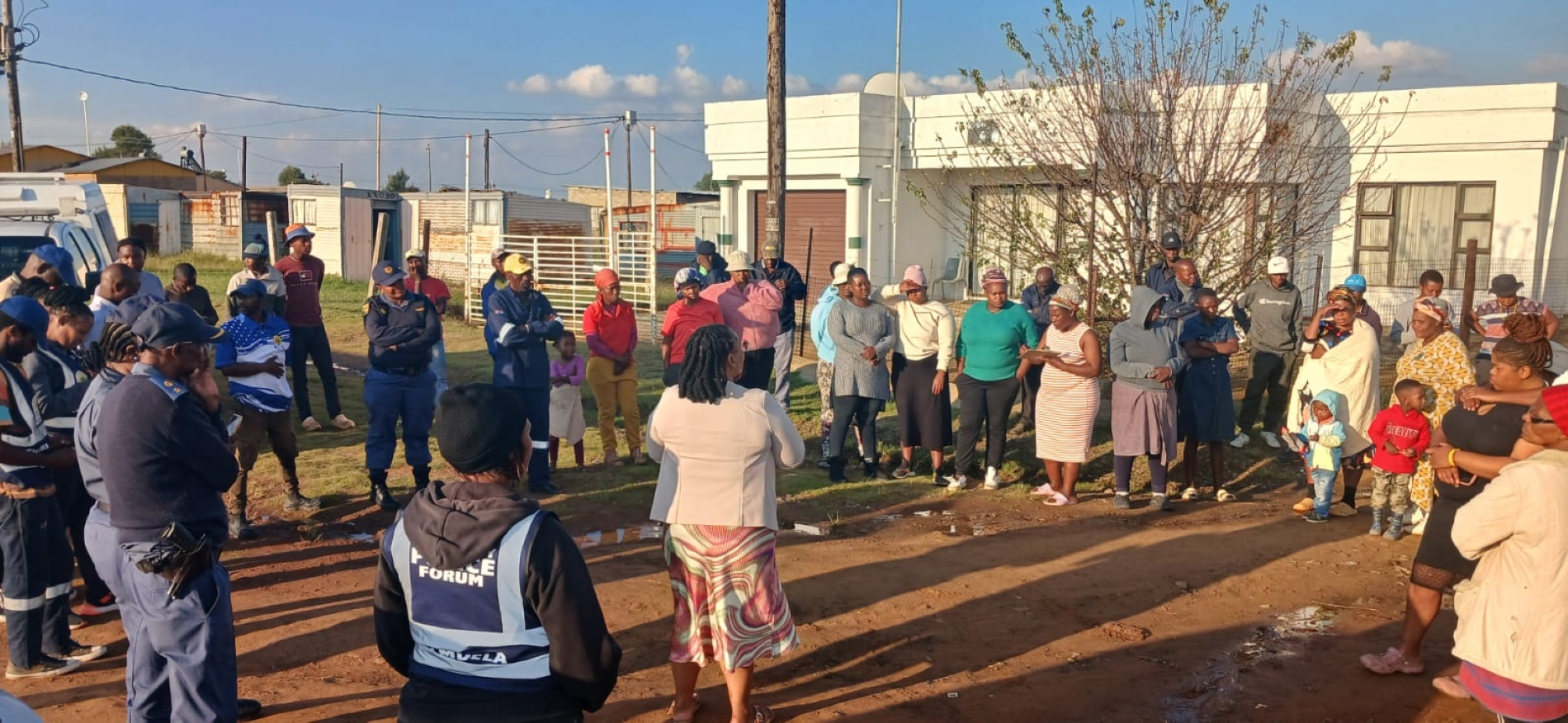 Residents of Zamdela gather with police and community leaders near the Dipereng informal settlement on 14 April.