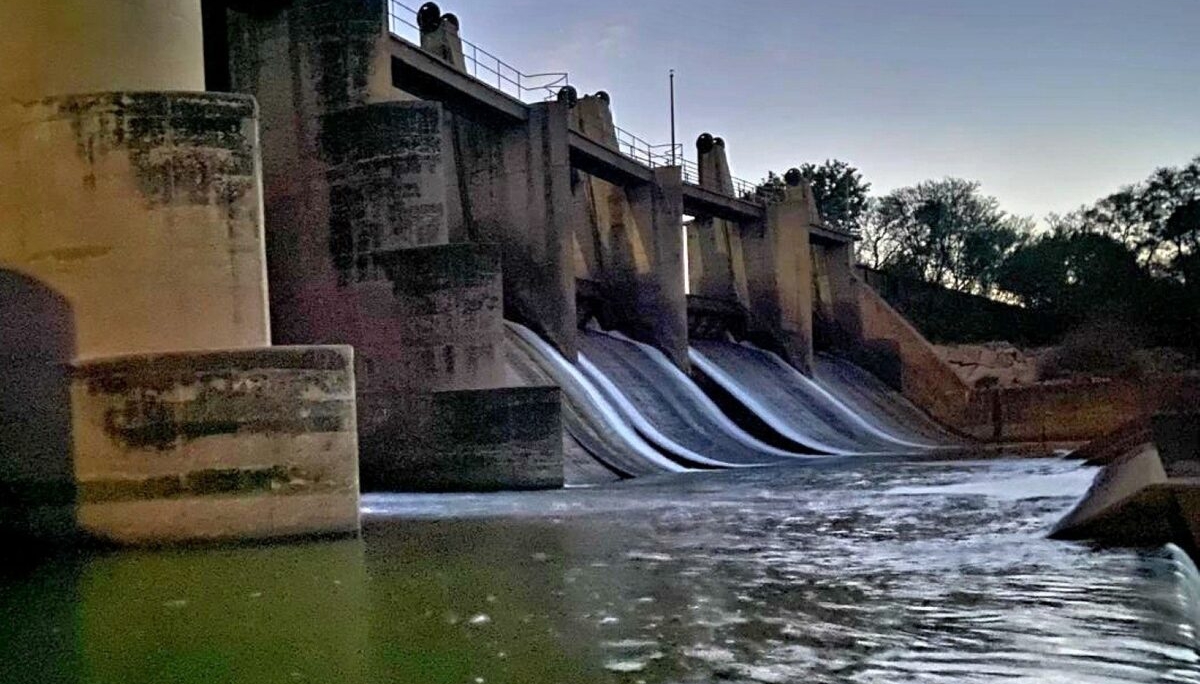 Water flows freely through the open sluice gates at the Serfontein Dam near Kroonstad, raising concerns about the loss of a vital water resource as the region braces for a potentially dry summer.