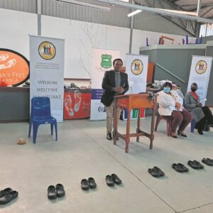 Speaker gifts shoes to kids