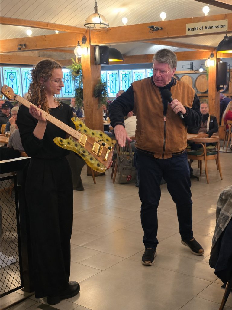 Johan Stemmet shows one his handmade ghitars donated for the auction.