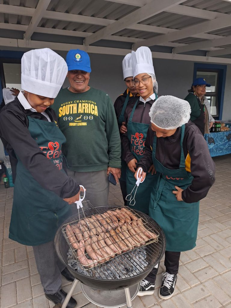 Kids braaing boerewors.