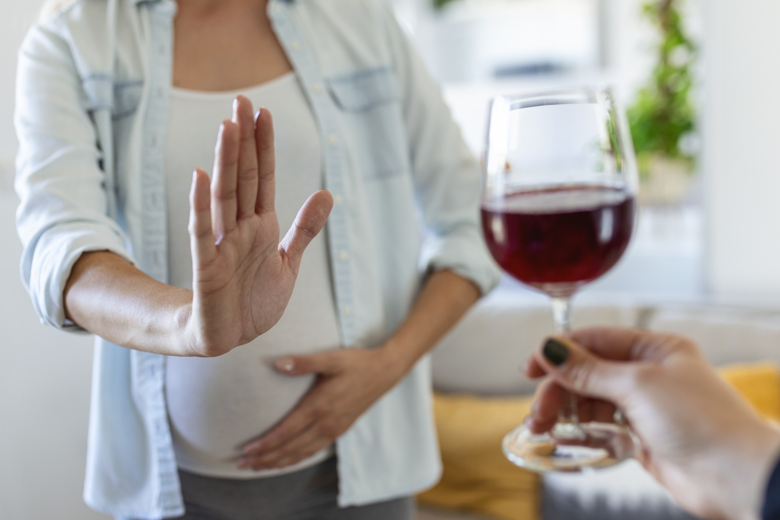 Pregnant mother saying to to alcohol.