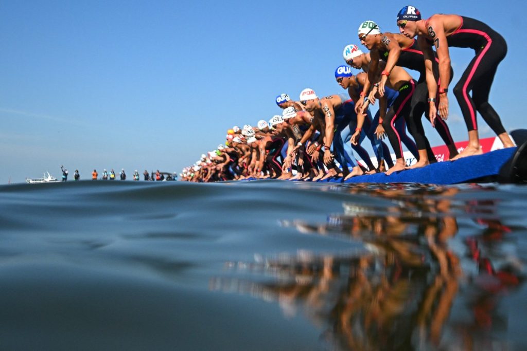 rance's swimmer Marc-Antoine Olivie) and fellow-swimmers dive into the water at the start of the final of the men's 5km open water swimming event during the 2025 World Aquatics Championships.