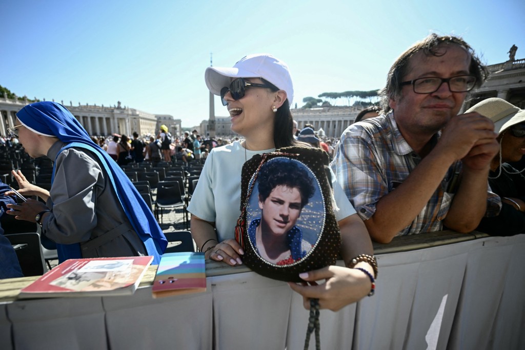 A member of the faithful holds a portrait of Saint Carlo Acutis, an adolescent who spent his life spreading his faith online, earning the moniker 'God's Influencer', during a Jubilee audience in Saint Peter's Square in the Vatican on Saturday (6 September). Photo: Filippo Monteforte, AFP