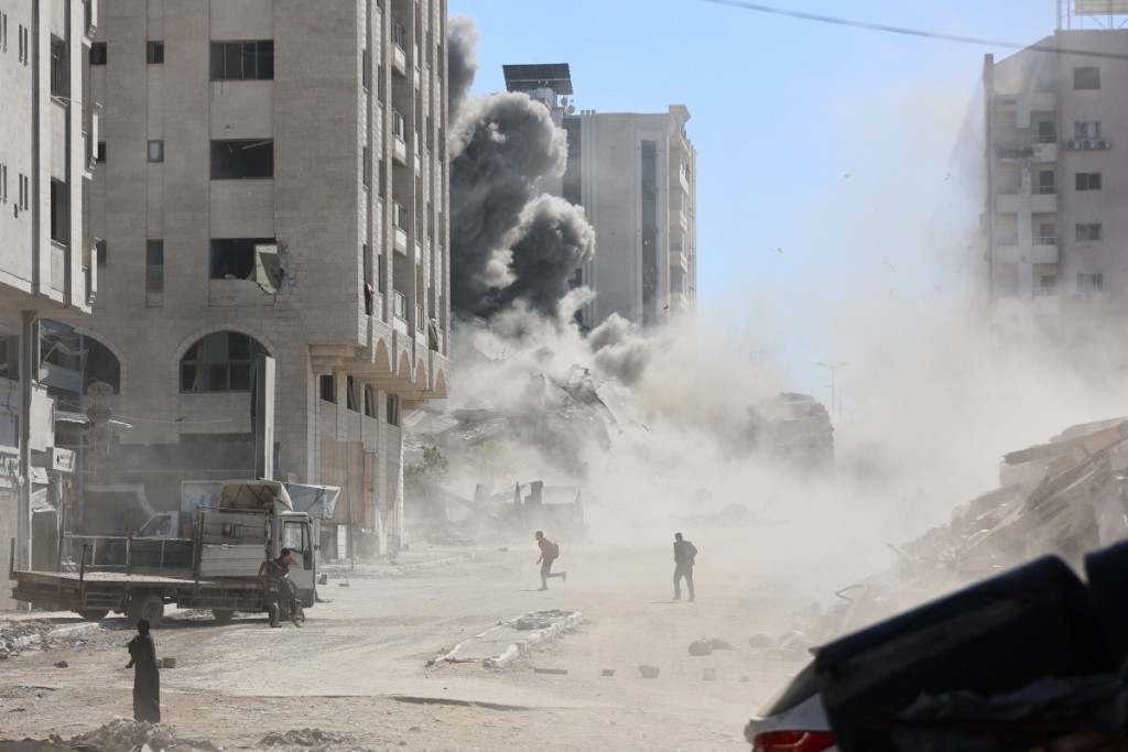 Smoke billows after an Israeli strike on a building in Gaza City's Tal al-Hawa district on September 13, 2025. The Israeli military said on September 13, that more than 250,000 people have left Gaza City for other parts of the territory over the past few weeks, since it intensified its assault on Gaza's largest urban centre. (Photo by Omar AL-QATTAA / AFP)