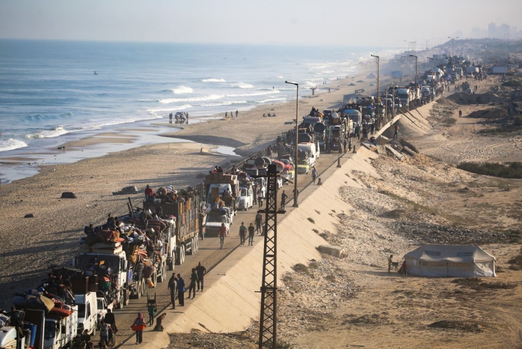 Displaced Palestinians move with their belongings southwards on a road in the Nuseirat refugee camp area in the central Gaza Strip following renewed Israeli evacuation orders for Gaza City on September 18, 2025. Israel has announced a major ground assault in Gaza City that it says is aimed at crushing Hamas in the Palestinian territory's largest urban hub. (Photo by Eyad Baba / AFP)