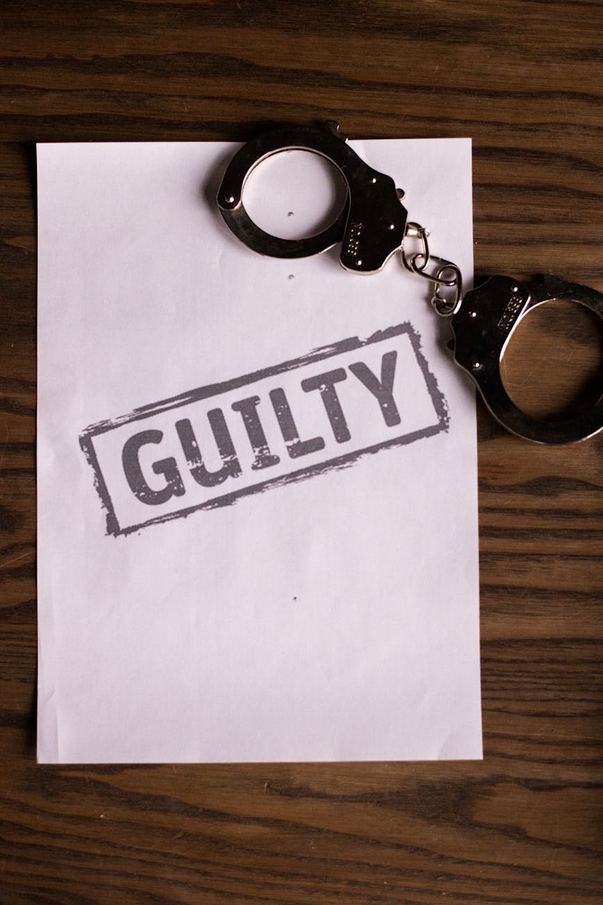 paper and handcuffs on a wooden surface