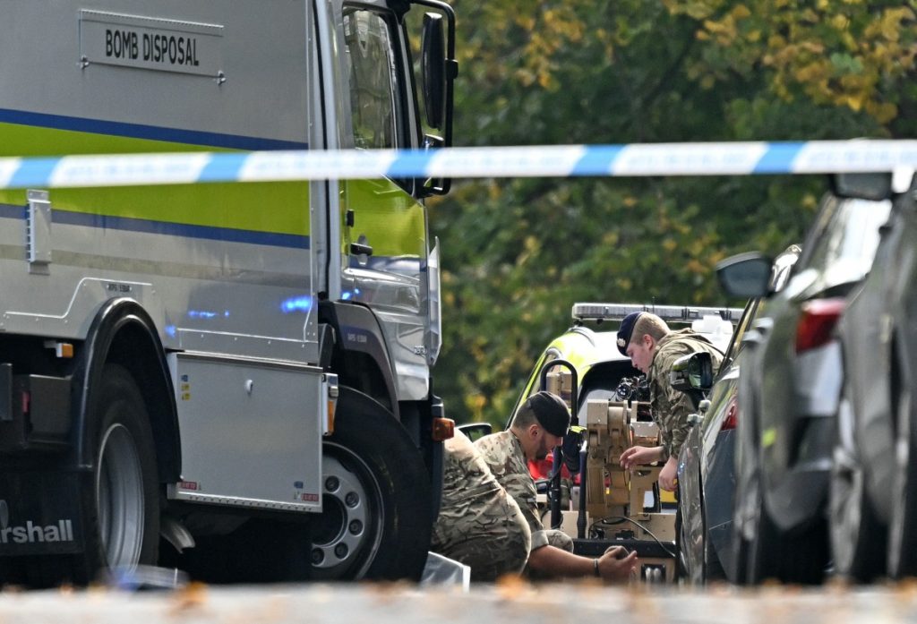 Members of the Armed Forces work by a bomb disposal van as they prepare a Harris T7 Multi-Mission Robot inside a Police cordon at Heaton Park Hebrew Congregation synagogue in Crumpsall, north Manchester, on October 2, 2025, following an attack at the synagogue. Two people were killed and three wounded in a car ramming and stabbing incident outside a synagogue in Manchester, northwest England, on Thursday, police said. "A man believed to be the offender was shot by GMP (Greater Manchester Police) Firearms Officers and is also believed to be deceased," the force said on X, adding his death could not yet be confirmed due to "suspicious items on his person". (Photo by Oli SCARFF / AFP)
