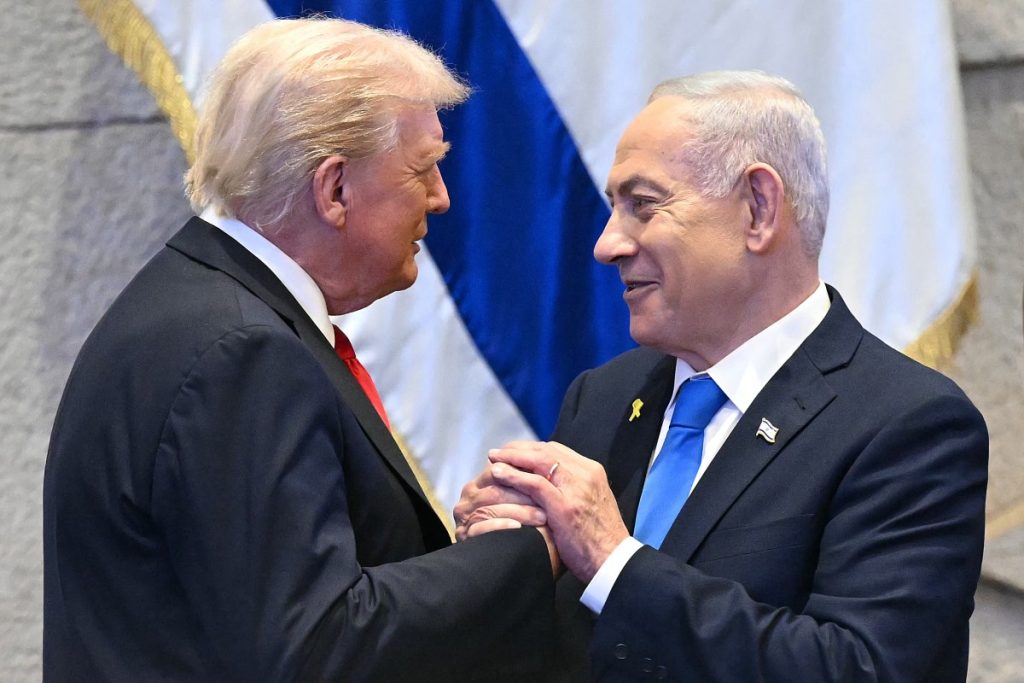 US President Donald Trump holds hands and speaks with Israeli Prime Minister Benjamin Netanyahu at the Israeli parliament, the Knesset, in Jerusalem on Monday. (Photo by Saul Loeb / AFP)