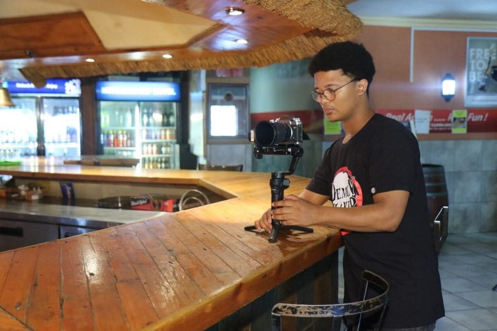 Llewellyn Breda with a video camera.