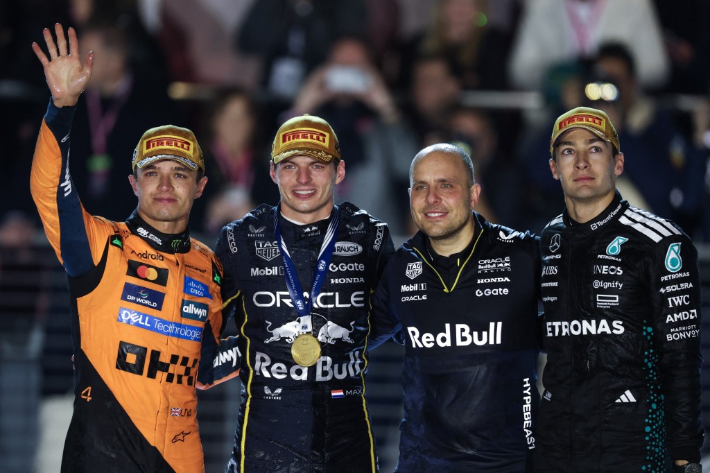 Lando Norris, Max Verstappen, George Russell, and Gianpiero Lambiase on the podium.