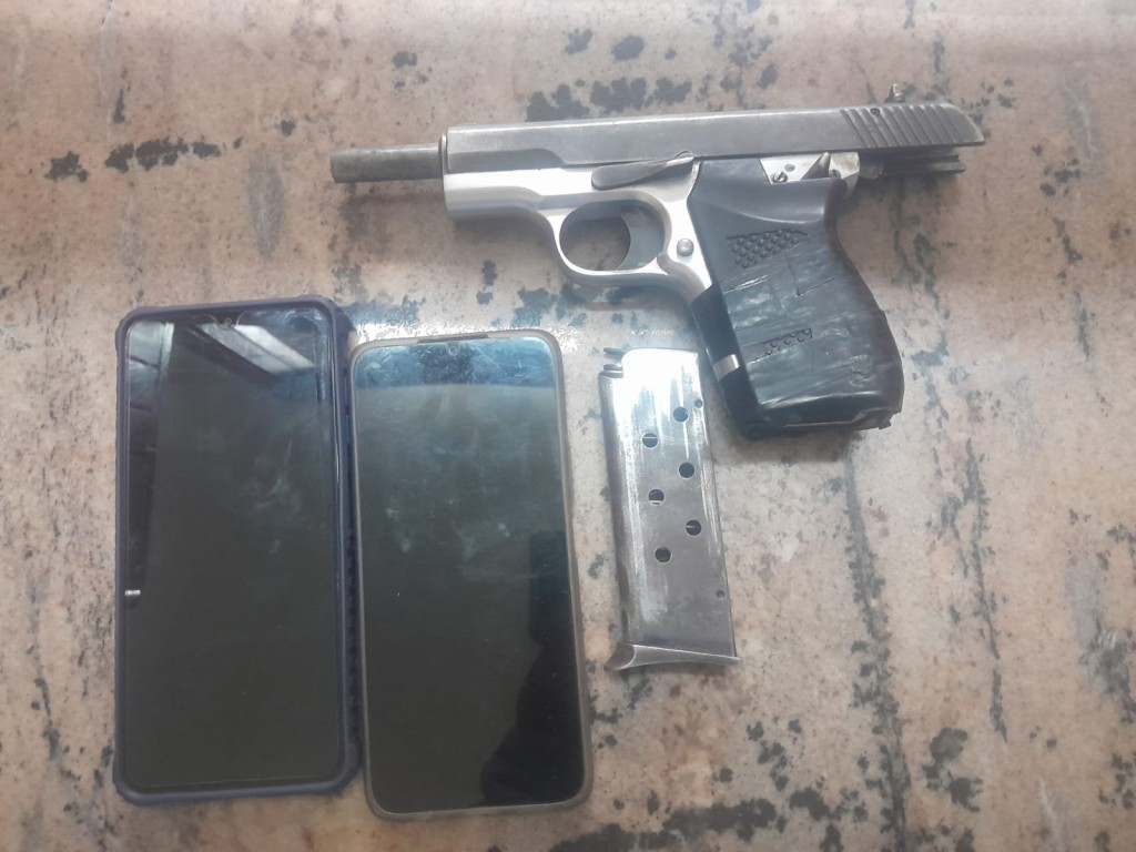 The firearm and cellphones confiscated by police.