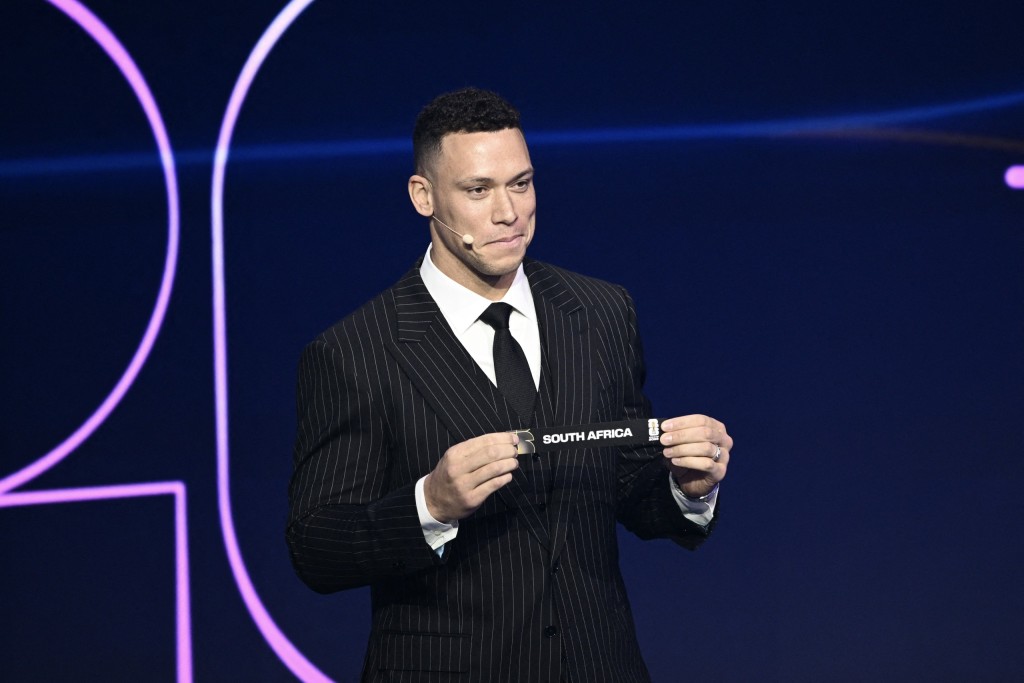 US Draw assistant Aaron Judge shows the card reading South Africa.