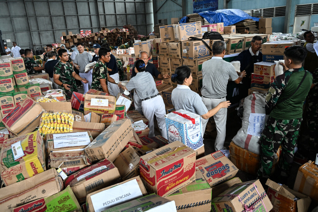 Soldiers and volunteers sort relief supplies inside a warehouse to be delivered to flood-affected areas in North Sumatra and Aceh, at Soewondo Air Base in Medan, North Sumatra, on December 12, 2025. Tropical storms and monsoon rains have pummelled Southeast and South Asia this month, triggering landslides and flash floods from the rainforests of Sumatra to highland plantations in Sri Lanka - and more rains are predicted. PHOTO: YT HARIONO / AFP