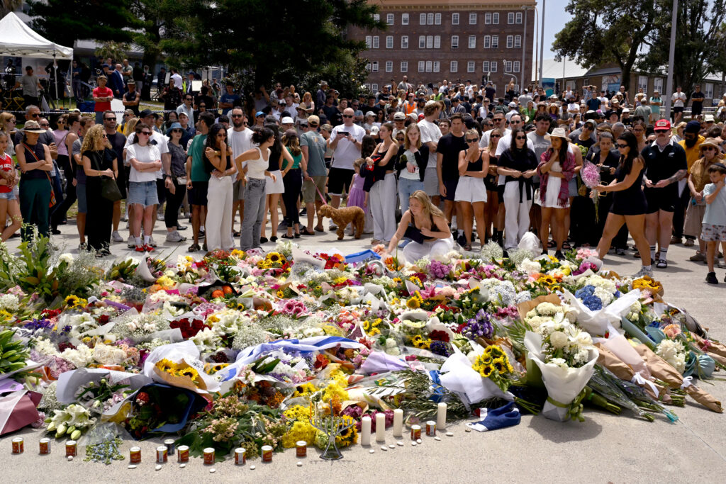 Mourners gather with floral tributes at the Bondi Pavilion.