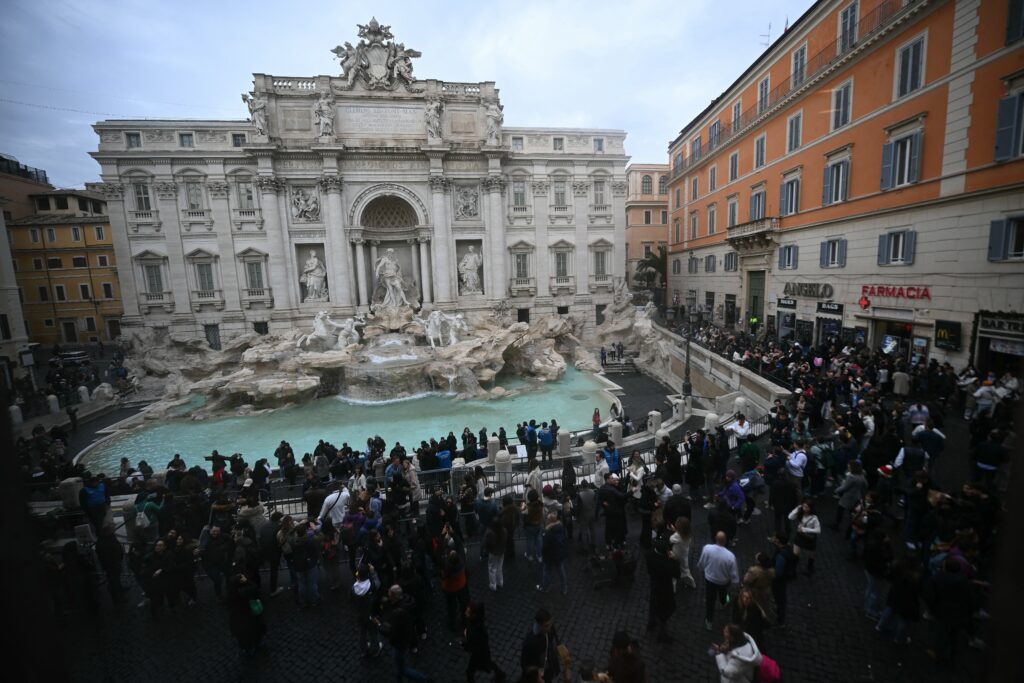 Tourists queue around the Trevi fountain in central Rome.
