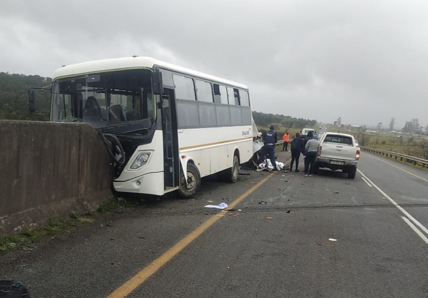 An accident scene involving a bus and car.