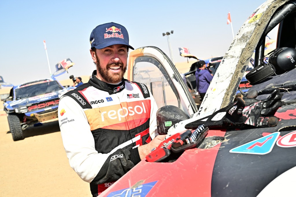 South African Toyota Gazoo Racing driver Henk Lategan works on his damaged car.