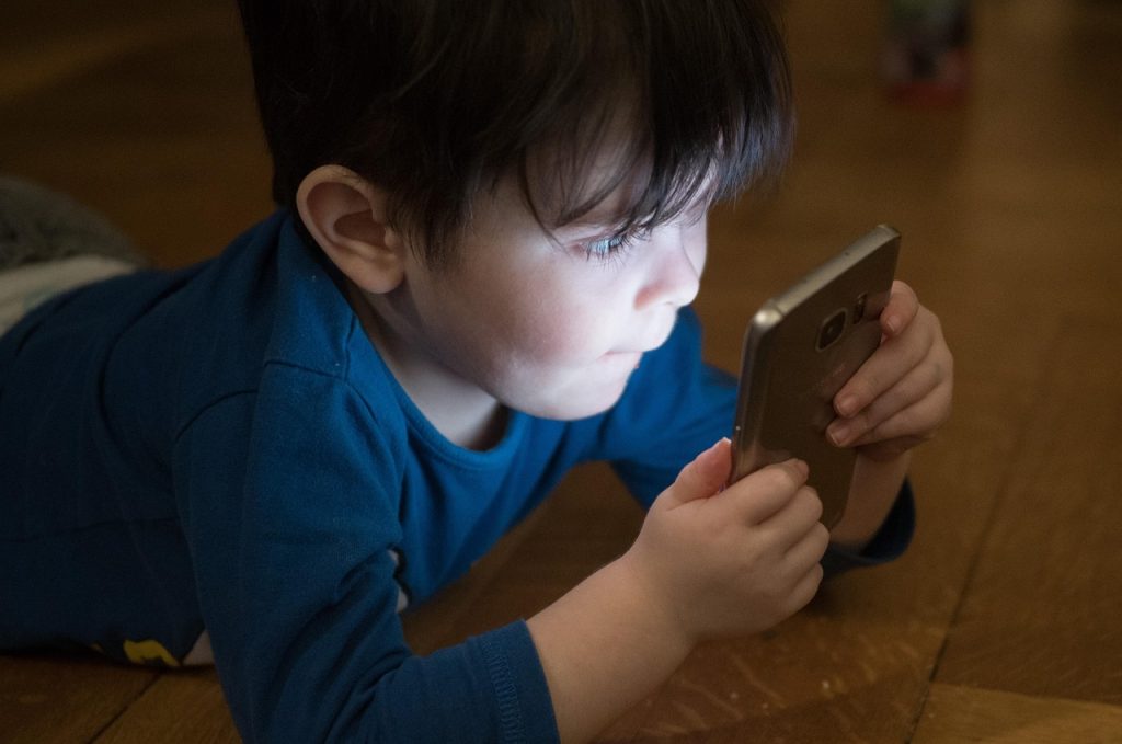 Young child looking at a smartphone screen.