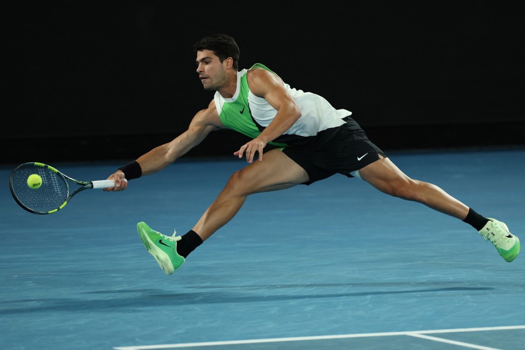 Spain's Carlos Alcaraz hits a return to Serbia's Novak Djokovic during their men's singles final match on day fifteen of the Australian Open tennis tournament in Melbourne on February 1, 2026. (Photo by Martin KEEP / AFP) / -- IMAGE RESTRICTED TO EDITORIAL USE - STRICTLY NO COMMERCIAL USE --
--