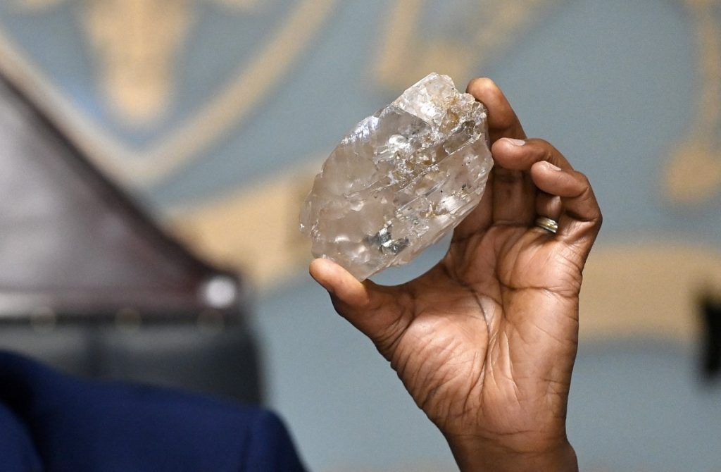 Botswana's President Mokgweetsi Masisi holds a large diamond discovered in Botswana.
