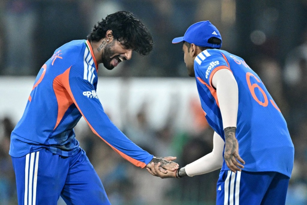 India's Tilak Varma (L) celebrates with captain Suryakumar Yadav after taking the wicket of Pakistan's Shadab Khan.