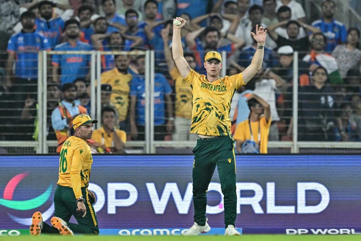 South Africa's Corbin Bosch (R) reacts after taking a catch to dismiss India's Abhishek Sharma during the 2026 ICC Men's T20 Cricket World Cup Super Eights match between India and South Africa.