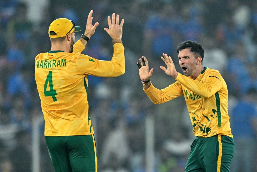 South Africa's Keshav Maharaj (R) celebrates with his captain Aiden Markram after taking the wicket of India's Hardik Pandya during the 2026 ICC Men's T20 Cricket World Cup Super Eights match between India and South Africa