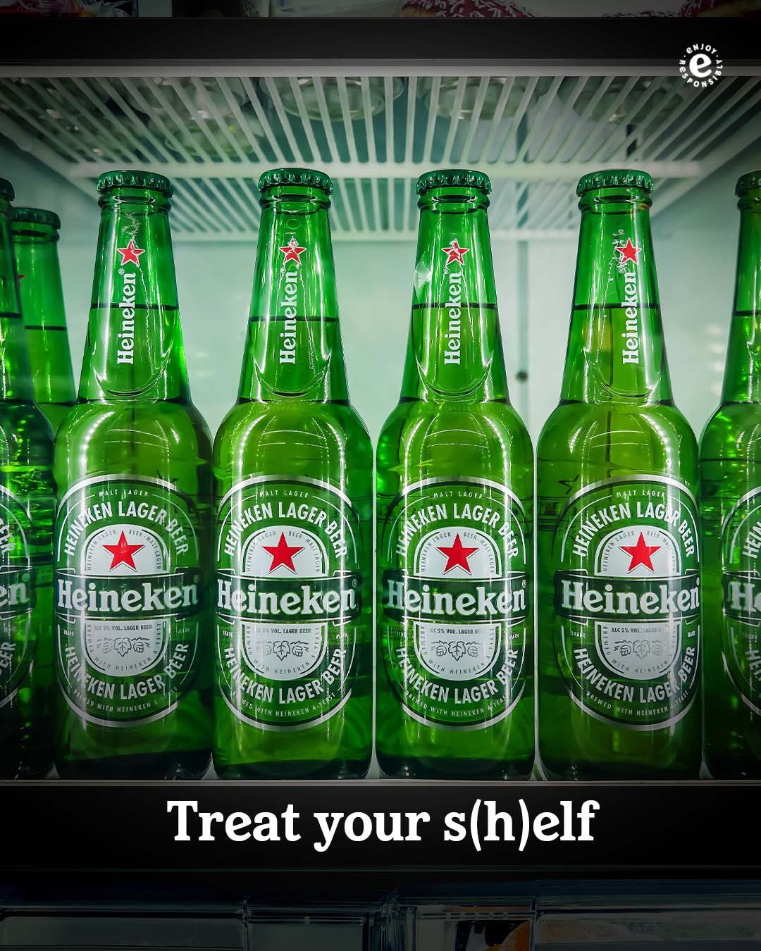 A display of multiple Heineken beer bottles and cans arranged together, showing the classic green Heineken branding and labels.