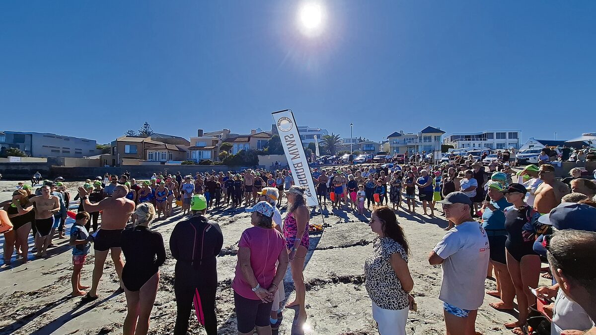 The Bloubergstrand ocean community forms a circle at Small Bay to honour John Flanigan’s life.