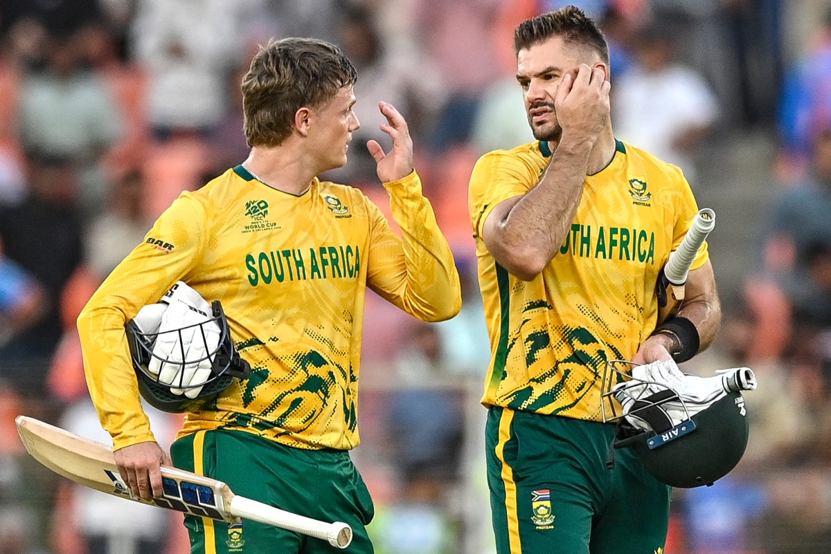 South Africa's captain Aiden Markram (R) and his teammate Ryan Rickelton walk off the field after their team's win in the 2026 ICC Men's T20 Cricket World Cup