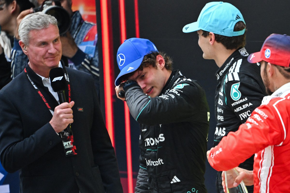First-placed Mercedes' Italian driver Kimi Antonelli celebrates winning alongside Mercedes' British driver George Russell (2R) and Ferrari's British driver Lewis Hamilton (R)
