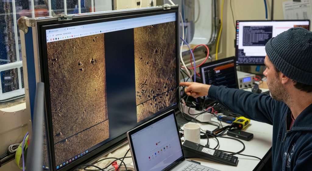 A scientist looks at digital scans of munitions and various spots of interest on the seabed in the Eastern Baltic Sea. 