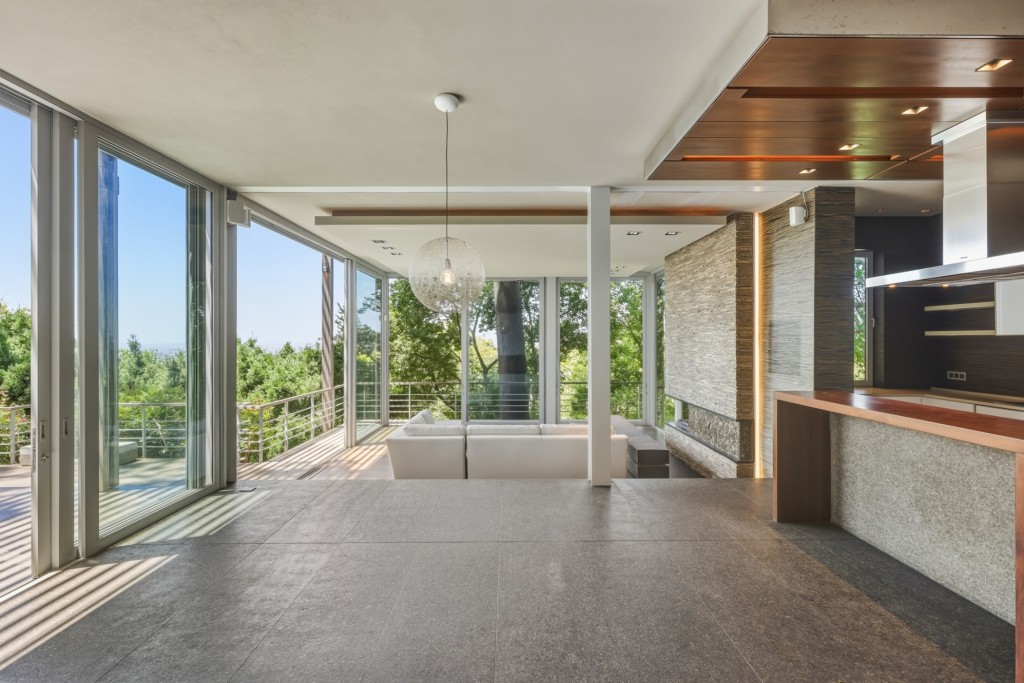 Forest House boasts a state-of-the-art kitchen that opens to an expansive indoor-outdoor entertainment area.