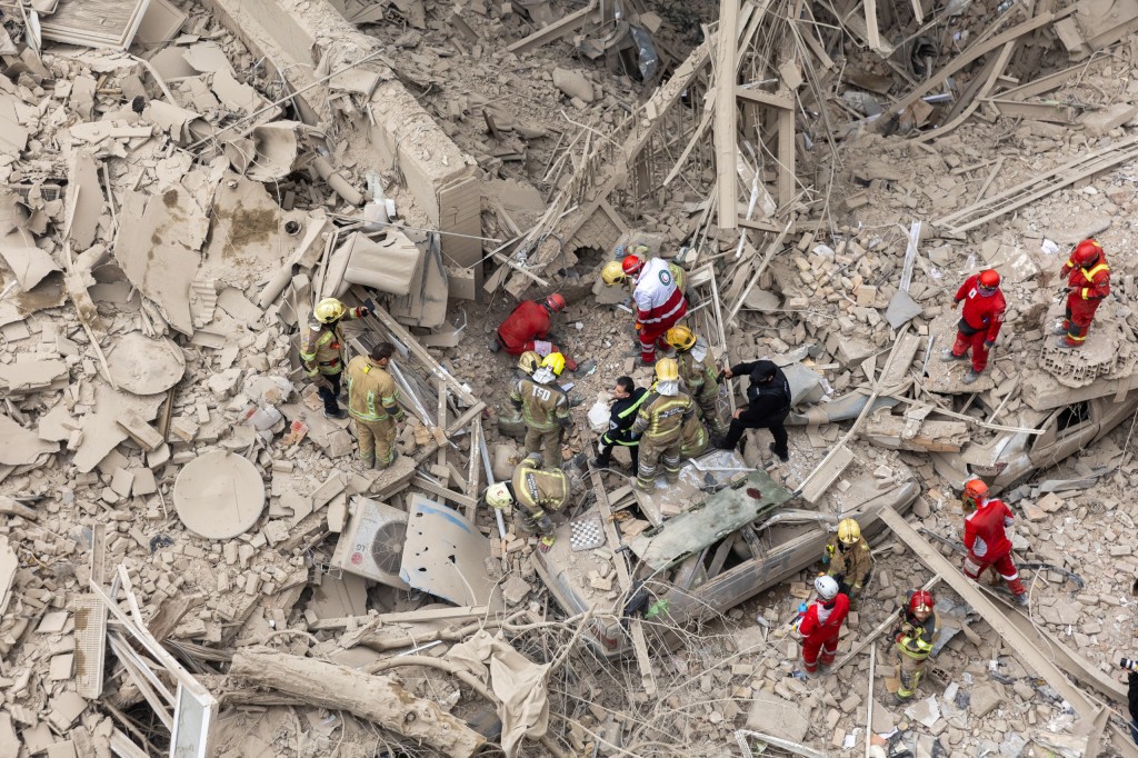 people trapped in rubble following a strike on a residential building on 16 March in central Tehran, Iran.